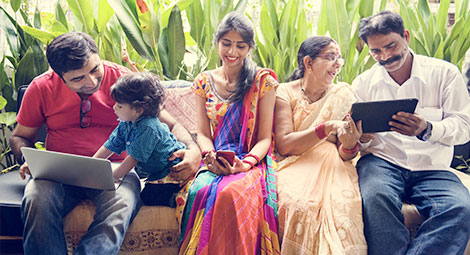 A family sat together on their electronic devices